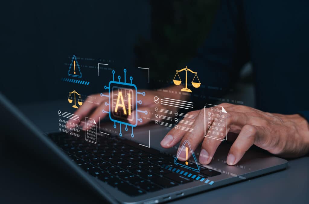 Person typing on a laptop with holographic AI and legal/policy icons floating above the keyboard, conveying AI and law collaboration.